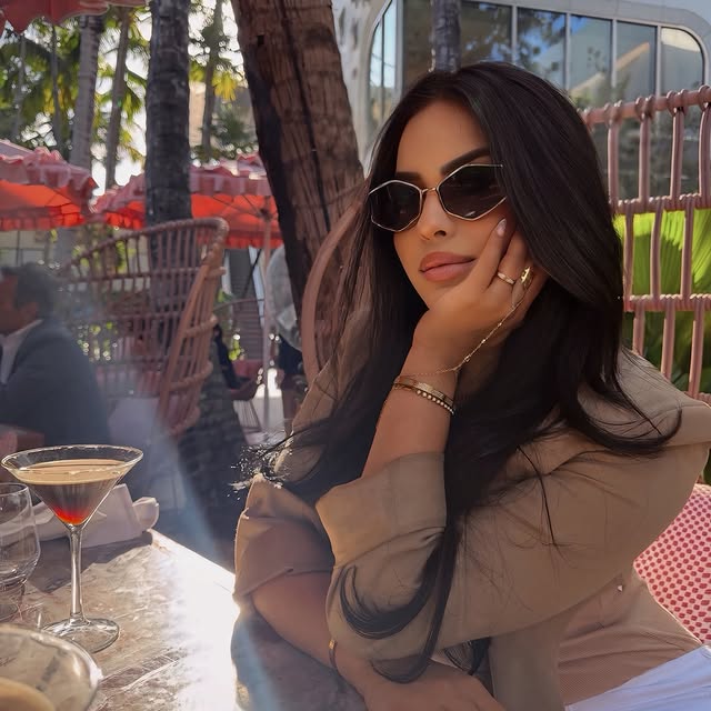 Cindy in a chic black outfit with sunglasses